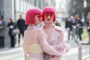 Two beautiful women wearing pink fashion sunglasses